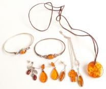 Two silver bangles set with pressed amber, two pairs of silver earrings set with pressed amber,