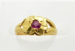 A gold child's ring set with a synthetic ruby
