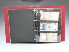 Approximately 100 mostly uncirculated overseas banknotes in a collector's album, including Congo,