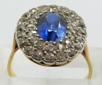 An 18ct gold ring set with a synthetic sapphire surrounded by old cut diamonds, 4.4g, size P/Q
