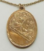 A 9ct gold locket with engraved decoration and chain, 3.5 x 2.5cm, 13.4g