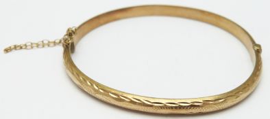 A 9ct gold bangle with cut out decoration, 6.1g