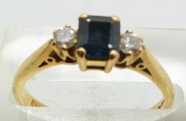 An 18ct gold ring set with a square cut sapphire and diamonds, 3.2g, size N