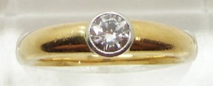 An 18ct gold ring set with a round cut diamond measuring approximately 0.3ct, 5.4g, size M