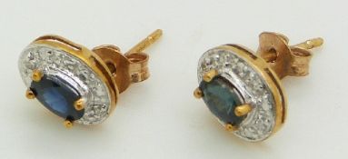 A pair of 9ct gold earrings set with sapphire and diamonds