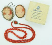 Two silver brooches set with cameos in a cameo box from Rome and a coral necklace, 20g.