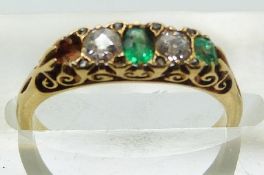 An 18ct gold ring set with diamonds and emeralds in original box, size K
