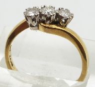 An 18ct gold ring set with three diamonds in a twist setting, each diamond approximately 0.2ct, 4.