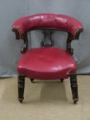 Oxblood red leather button back and carved mahogany library or captain's chair