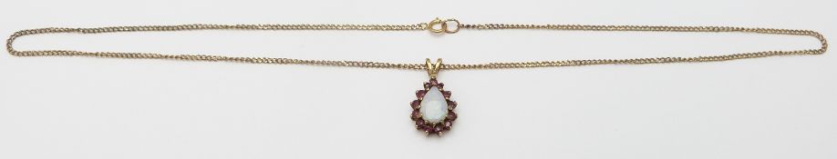A 9ct gold pendant set with a pear cut opal and rubies, 3.7g