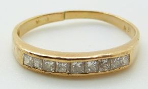 A yellow metal ring set with nine princess cut diamonds, 1.7g