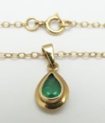 A 9ct gold necklace set with a pear cut emerald, 2.9g