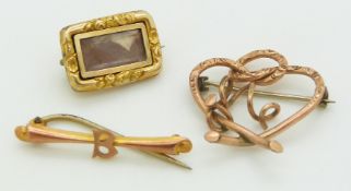 Two yellow metal brooches and a Victorian mourning brooch
