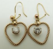 A pair of bespoke 9ct gold earrings each set with a diamond measuring approximately 0.4ct in a heart