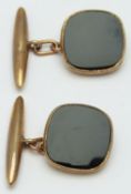 A pair of 9ct gold cufflinks set with black enamel, 6.1g