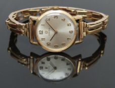 Omega 9ct gold wristwatch ref. 511.5137 with black hands, gold Arabic numerals, silver dial and