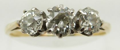 An 18ct gold ring set with three old cut diamonds, the centre diamond approximately 0.48ct, Size