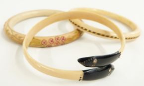 A 1920's Art Deco ivory flapper bangle with elephant hair to the centre, Art Deco snake flapper