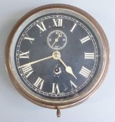 Brass ship's bulkhead clock with black Roman dial and Arabic secondary seconds, marked 'Made in