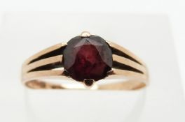 A 9ct gold ring set with a round cut garnet, 1.7g, size M