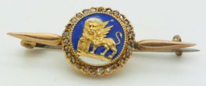 A yellow metal brooch set with enamel surrounded by diamonds, length 4cm