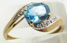 A 9ct gold ring set with a blue topaz and diamonds, 2.6g, size S