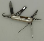 19thC miniature multi-tool penknife with 7 blades and white metal sides, approximate length 4.5cm