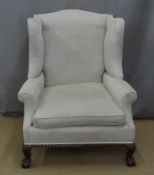 19thC wing back armchair raised on ball and claw feet