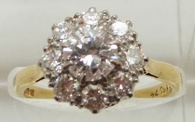An 18ct gold ring set with a cluster of diamonds, the centre diamond measuring approximately 0.75ct,
