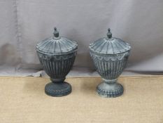 Two lidded cast iron urns, height 43cm, copper coal bucket and a brass trivet