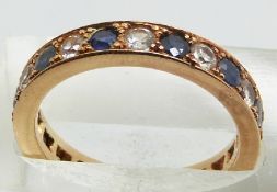 A 9ct gold eternity ring set with alternating sapphires and white sapphires, 4.1g, size N