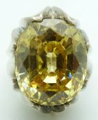 A large silver dress ring set with a large oval cut treated topaz