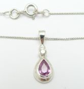 A 9ct white gold necklace set with a pear cut pink sapphire and a round cut diamond, 1.9g