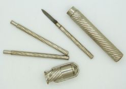 A silver plated writing etui tool set, the wrythen turned body with catch to top set with travelling