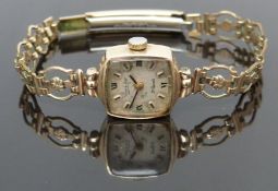 Everite 9ct gold ladies wristwatch with black hands, Roman numerals and silver dial, on gold