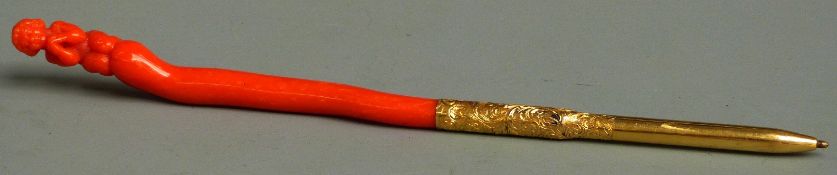 Coral and yellow metal pen the metal body with chased decoration and the coral handle carved in