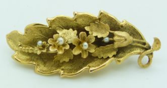 Victorian brooch/ pendant set with seed pearls in a textured floral and leaf design, 4.8g, 5 x 2cm