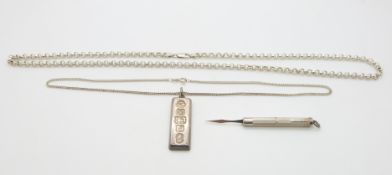A silver ingot, silver toothpick and two silver necklaces