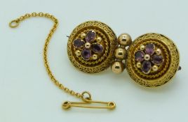 Victorian Etruscan Revival gold brooch set with foiled amethysts within applied rope twist