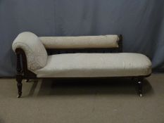 Victorian upholstered mahogany chaise longue with carved detail, raised turned legs and ceramic