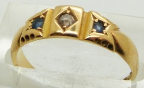 An 18ct gold ring set with an old cut diamond and two sapphires, Chester 1891, 2.6g, size M