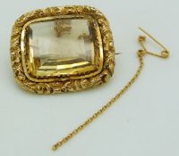 Victorian gold brooch set with a mixed cut citrine within a scrolling border, 10.5g, 3 x 2.6cm
