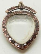 An early Victorian heart locket set with foiled garnets and bevelled glass