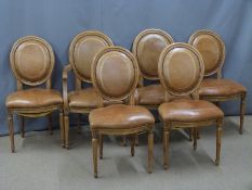 A set of six (4+2) French style leather upholstered dining chairs