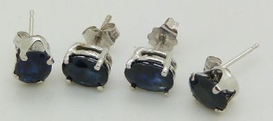 Two pairs of 14ct white gold earrings set with oval cut sapphires