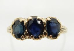 A 9ct gold ring set with three sapphires, 2.0g, size O