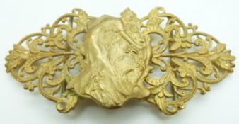 Art Nouveau gilt buckle depicting a lady picking flowers