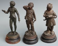 Three spelter figures of children/scholars with books, tallest 30cm