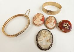 Three cameo brooches, a gold plated bangle and a Victorian gold plated bangle set with paste