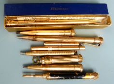 Nine gold plated and yellow metal propelling pencils, one an Eversharp example in original box.